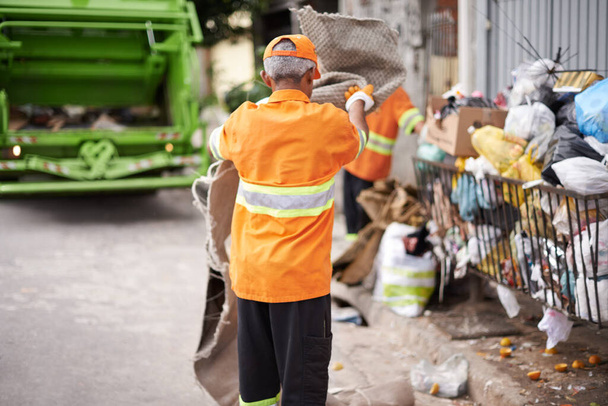 Garbage collection day. a busy garbage collection worker - Fotoğraf, Görsel