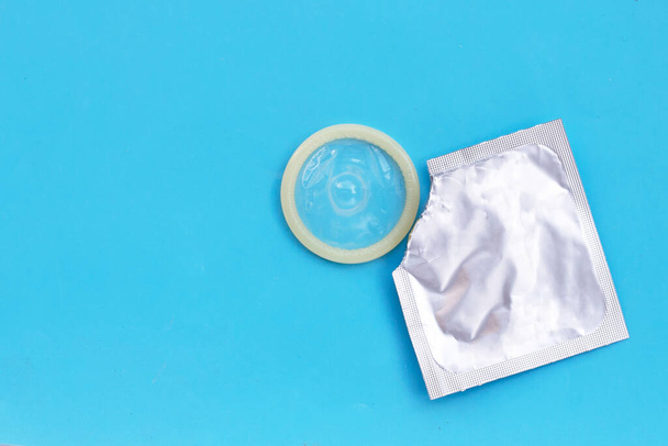 Condom on blue background. Copy space - Photo, Image