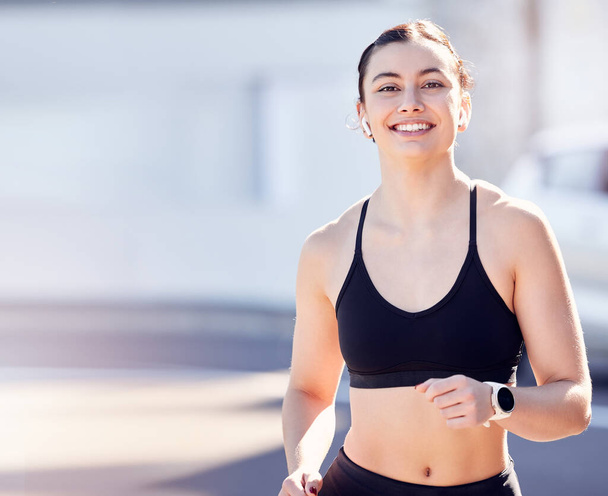 Exercise, woman and running in city with mockup, fitness and energy for healthy lifestyle, wellness or sports. Portrait of happy athlete, runner and mock up for training workout with music motivation. - Photo, image