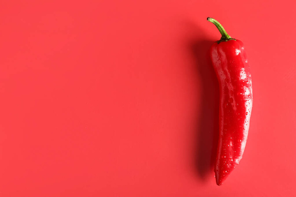 Fresh chili pepper on red background - Foto, afbeelding
