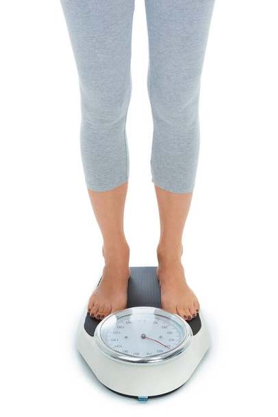 Finally seeing results. A cropped image of a woman standing on a scale - Photo, Image