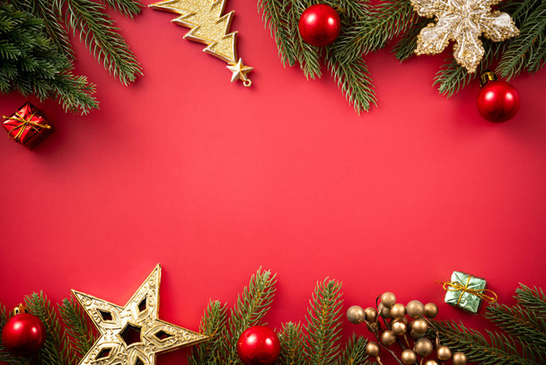 Koncepcja projektu tła Bożego Narodzenia, dekoracji świątecznej kompozycja ozdoba z gałęzi choinki, gwiazda z miejsca kopiowania izolowane na czerwonym stole. - Zdjęcie, obraz