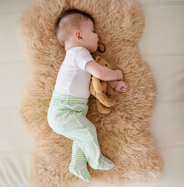 He always naps after feeding. an adorable baby boy taking a nap - Foto, imagen