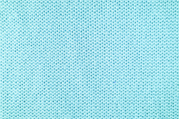 Primer plano del fondo de tejido de lana de punto hecho de hilo viscosa. Textura de punto de lana color turquesa pastel. Fondo abstracto de punto jersey. Fondo abstracto de tela, fondo de pantalla - Foto, Imagen