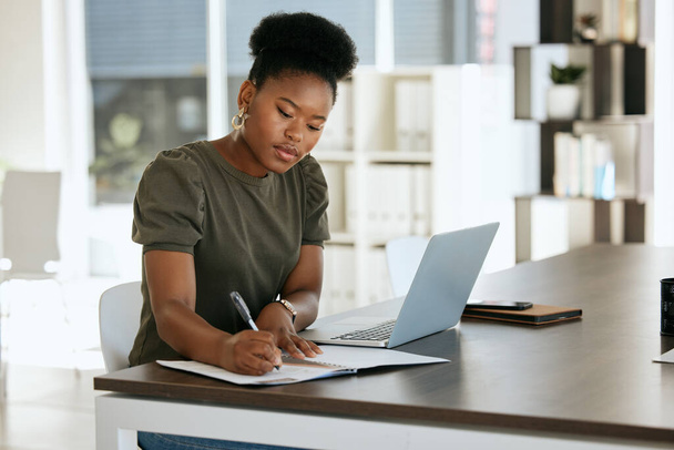 Corporate black woman, notebook and writing in planning, schedule or strategy for job as receptionist. Woman, professional and laptop on table by book, working or thinking of idea for research notes. - Foto, immagini