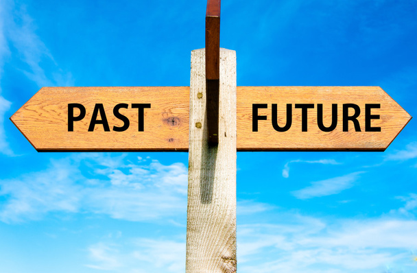 Wooden signpost with two opposite arrows over clear blue sky, Past versus Future messages, Mindset conceptual image - Photo, Image