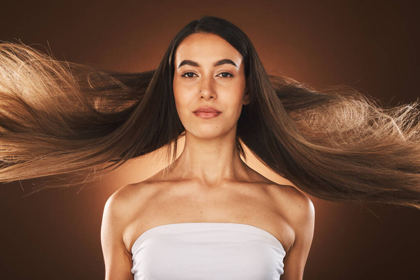 Hair care, beauty and woman cosmetics, makeup and shampoo advertising or marketing in brown studio background. Model, long hair and portrait with wellness, self love and self care for facial cosmetic. - Фото, зображення