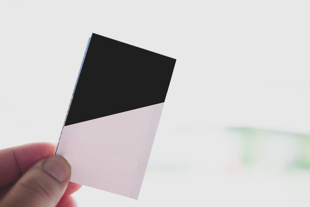 Eine Hand hält eine Kinokarte aus Papier. Leere Ticketvorlage, die Sie selbst entwerfen können. - Foto, Bild