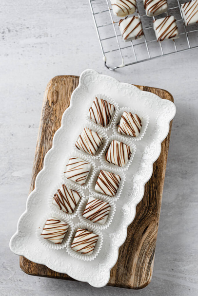 Beautiful and delicious homemade cookies or sweets with white and dark chocolate in retro grunge style. - Foto, imagen