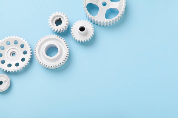 White gears wheels flat lay symbolizing idea, cooperation or teamwork, work and connection concept - Photo, Image