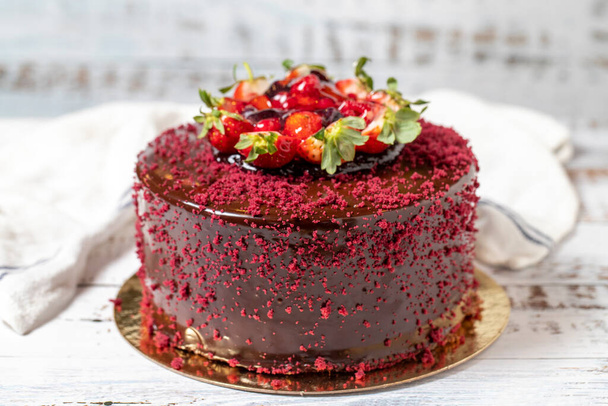 Fruit cake. Celebration or birthday cake on a white wood background. close up - Zdjęcie, obraz
