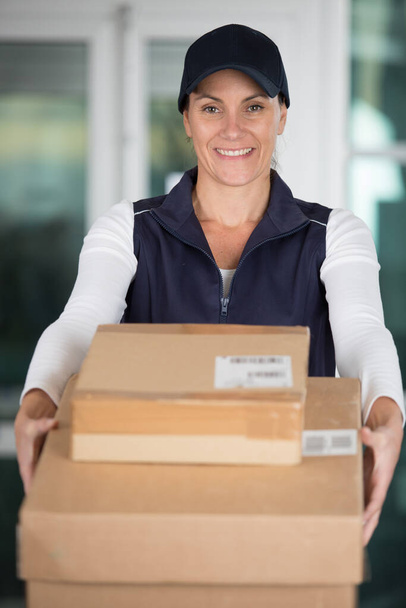 close up of woman giving boxes - Photo, Image