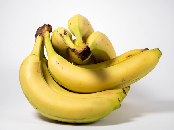 Banana on a white background. Ripe bananas on a light background. Close-up. - Foto, imagen