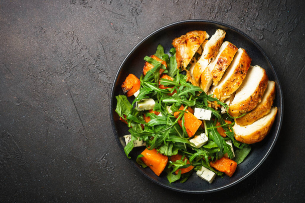 Chicken salad with pumpkin, blue cheese and arugula. Dash diet, keto diet meal. Top view image. - Photo, Image