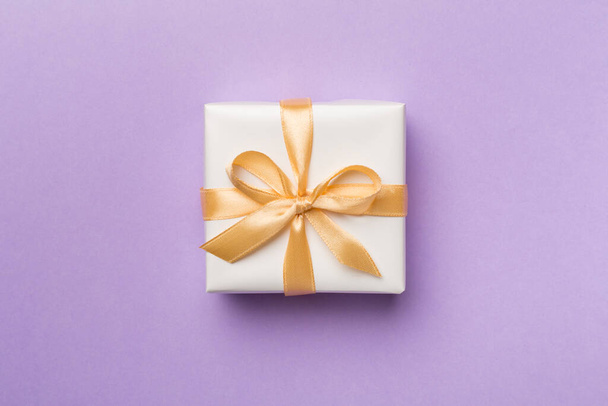 White gift box on color background, top view. - Foto, Imagen