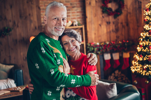 Photo of sweethearts old pensioners wear cute ugly sweaters cuddle smiling stay home every year tradition spend winter holidays together indoors. - Valokuva, kuva