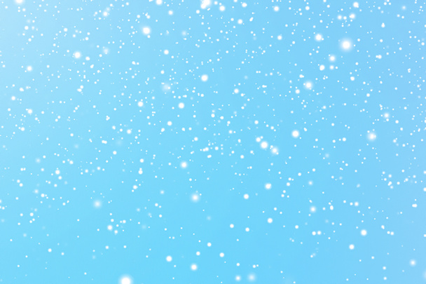 Winter holidays and wintertime background, white snow falling on blue backdrop, snowflakes bokeh and snowfall particles as abstract snowing scene for Christmas and snowy holiday design. High quality - Photo, Image
