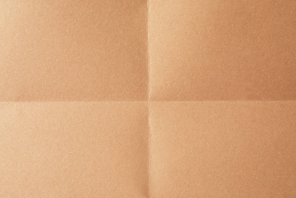 Folded kraft paper sheet as background, top view - Fotografie, Obrázek