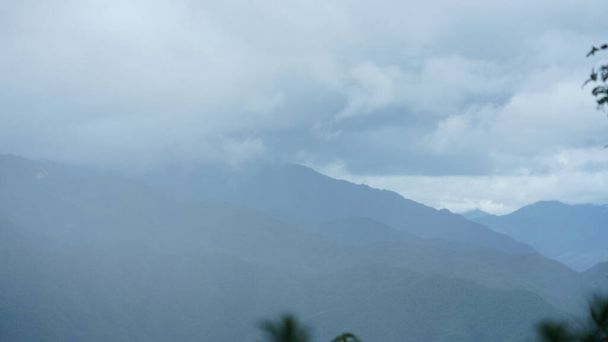 The raining mountains view with the foggy and misty raining droplets - 写真・画像