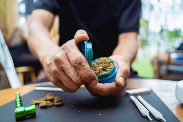 Young man making cigarettes with medical marijuana. - Фото, зображення