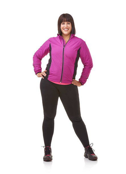 Ready to get fit. Portrait of a plus-size model in exercise clothes against a white background - Fotó, kép