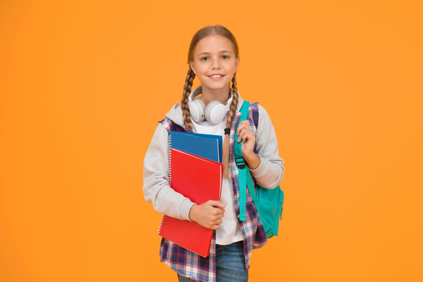 Hello school. Happy girl ready for school on yellow background. Little kid hold books and school bag. Small child back to school in autumn. Education and knowledge. - Φωτογραφία, εικόνα