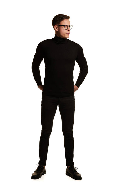 Full-length portrait of stylish handsome businessman in total black outfit posing isolated on white background. Concept of beauty, fashion, style and business. Human emotions and mental health - Foto, afbeelding