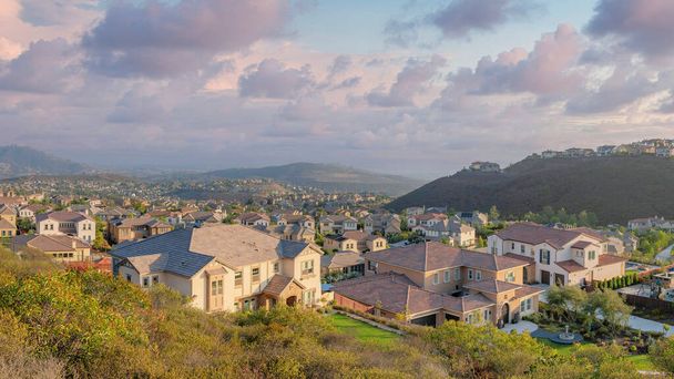 Panorama Puffy clouds at sunset Suburban residences on a mountain from the view at Double Peak Park. High angle view of San Marcos community at California with roads and large houses. - Photo, Image