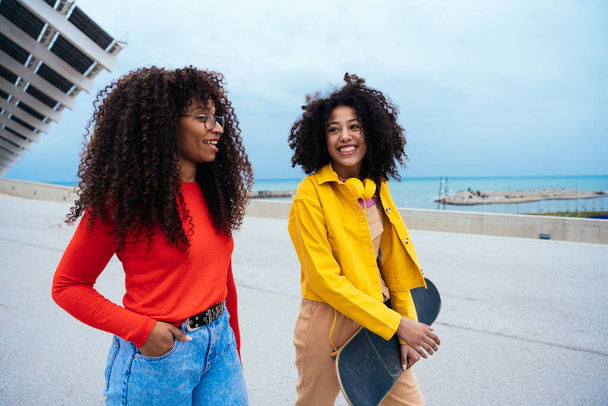 young happy women having fun outdoor , laughing and sharing good mood. Teenagers girls walking at the harbor in Barcelona after school - Foto, Bild