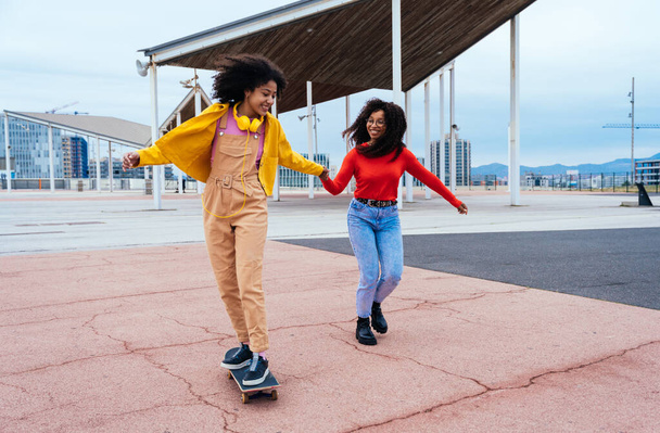 young happy women having fun outdoor , laughing and sharing good mood. Teenagers girls walking at the harbor in Barcelona after school - Fotó, kép