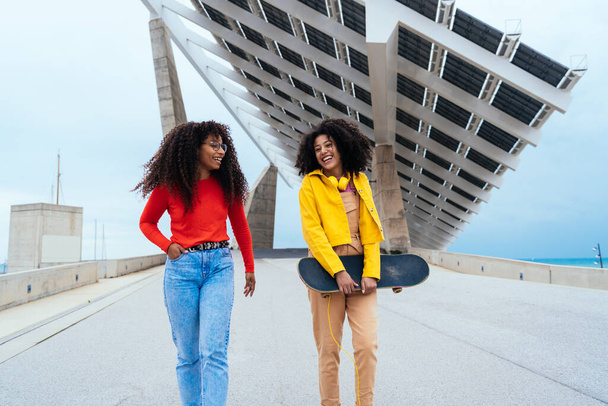 young happy women having fun outdoor , laughing and sharing good mood. Teenagers girls walking at the harbor in Barcelona after school - Fotó, kép