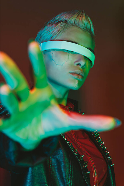 Representation of a bionic super human with advanced technology parts as vr visors and gadgets playing in a mixed reality training room. Futuristic cyberpunk evolution of human mankind and AI - Fotografie, Obrázek