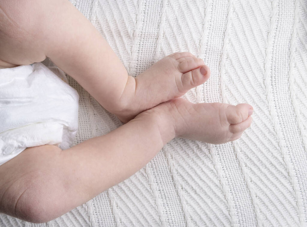 legs of a baby or a newborn child on a light background close-up.  - Photo, Image