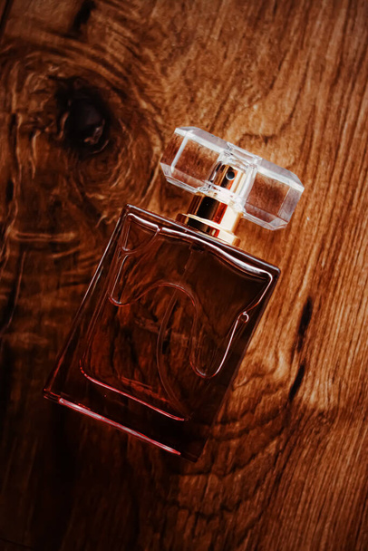 天然木の背景に古典的な香水瓶、エレガントな香りと高級香り. - 写真・画像