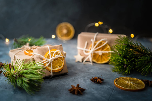 Zero waste Christmas concept. Eco-friendly kraft paper wrapping gifts on a slate table. DIY gifts, eco decor. Copy space, banner. - Photo, Image