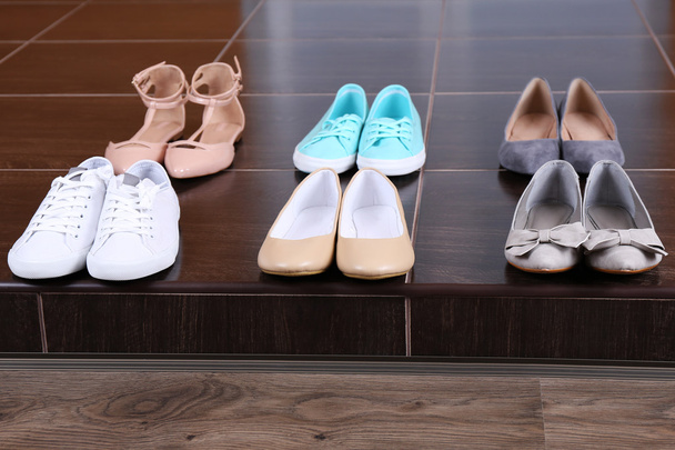 Different shoes on floor - Foto, afbeelding