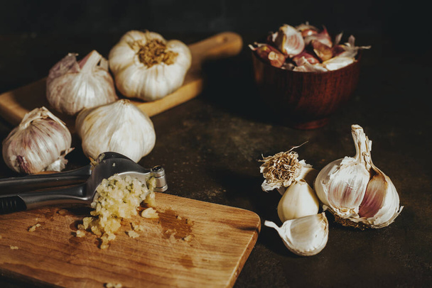 Garlic press with garlic cloves - Photo, Image