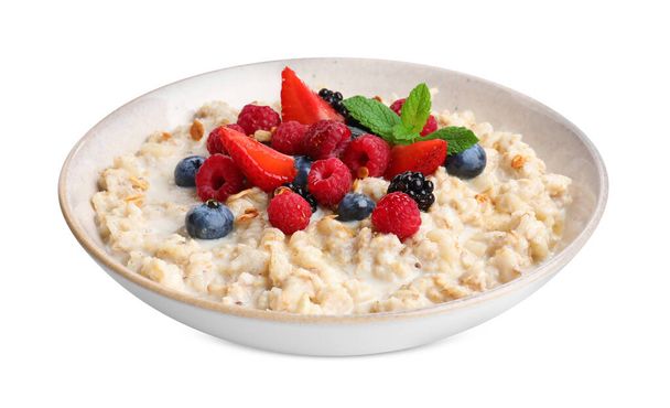 Bowl of oatmeal porridge with berries isolated on white - Photo, Image