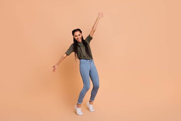Full size photo of cheerful charming girl dancing chilling good mood isolated on beige color background. - Foto, immagini
