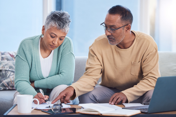 Senior black couple, taxes and home with laptop, documents or focus in home for family finance. Elderly, woman and man with computer, tablet or notebook in audit, budget or planning on lounge sofa. - Photo, Image