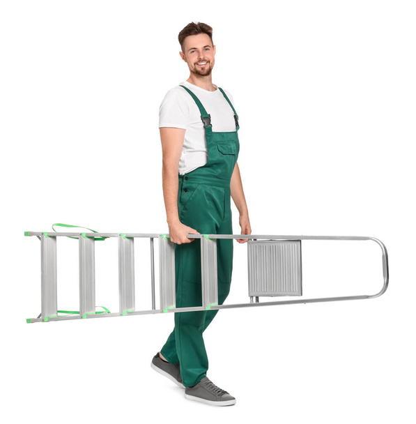 Worker in uniform holding metal ladder on white background - Photo, Image