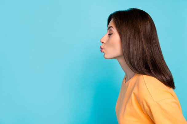 Profile photo of lovely cute person closed eyes pouted lips kiss empty space isolated on blue color background. - Foto, Bild