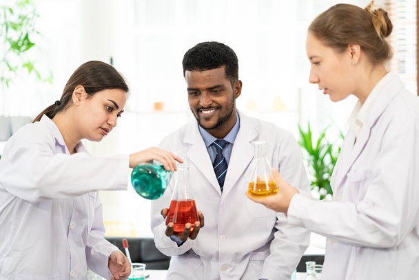 Portraits of a diversity of scientists smile in a research laboratory. Group of chemistry students working on hemp plant and Marijuana research in the lab. Concept of alternative herbal medicine, CBD - Foto, imagen