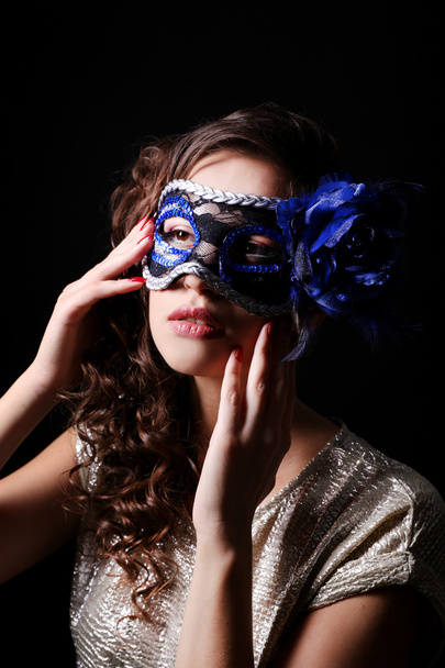 Beautiful girl with masquerade mask on dark background - Foto, afbeelding