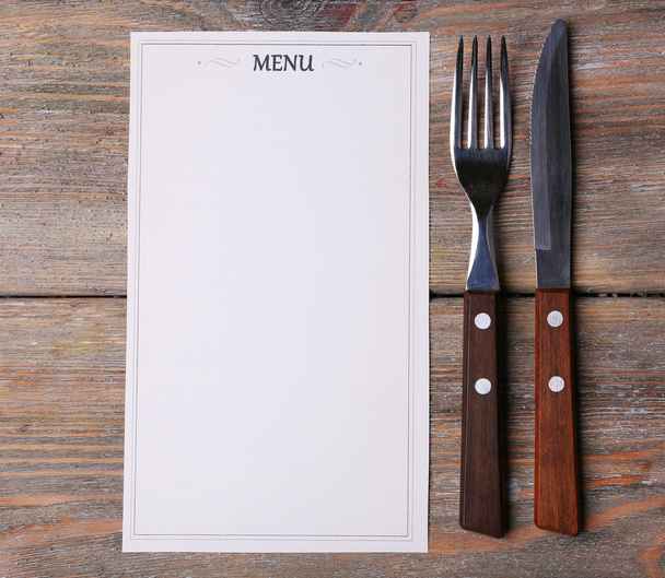 Menu sheet of paper on rustic wooden surface background - Фото, изображение