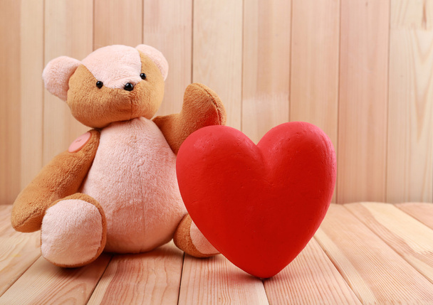 Teddy Bear with red heart on wooden background - Fotoğraf, Görsel