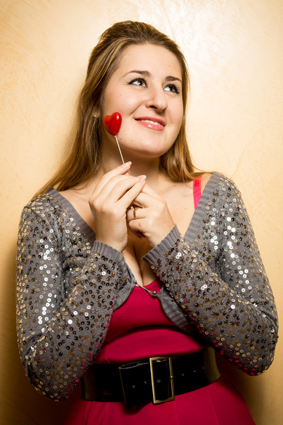 cute smiling woman holding decorative heart on stick - Фото, зображення