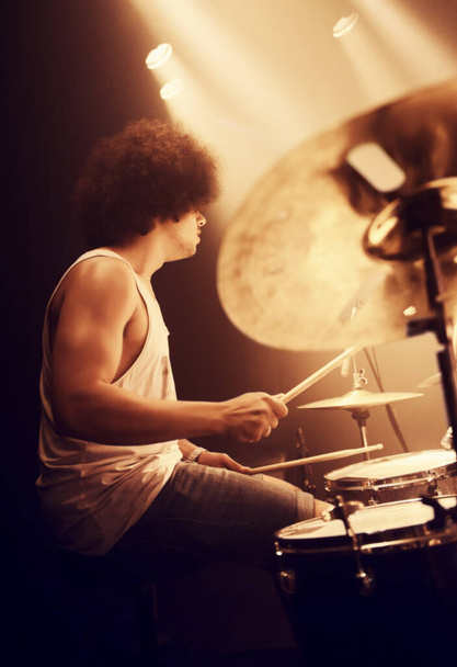Hes got mad skills. A talented drummer playing drums at a show - Фото, изображение