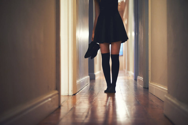 On her way out. Cropped image of a young woman walking down the hallway in her house - Fotó, kép