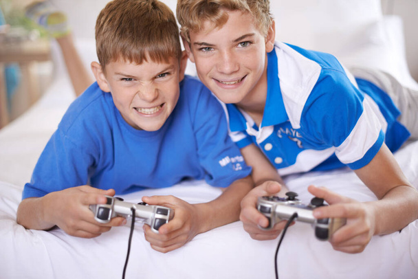 This game just got interesting. Two brothers playing video games - Photo, Image